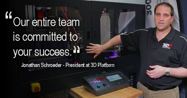 Jonathan Shroeder standing in front of machinery 